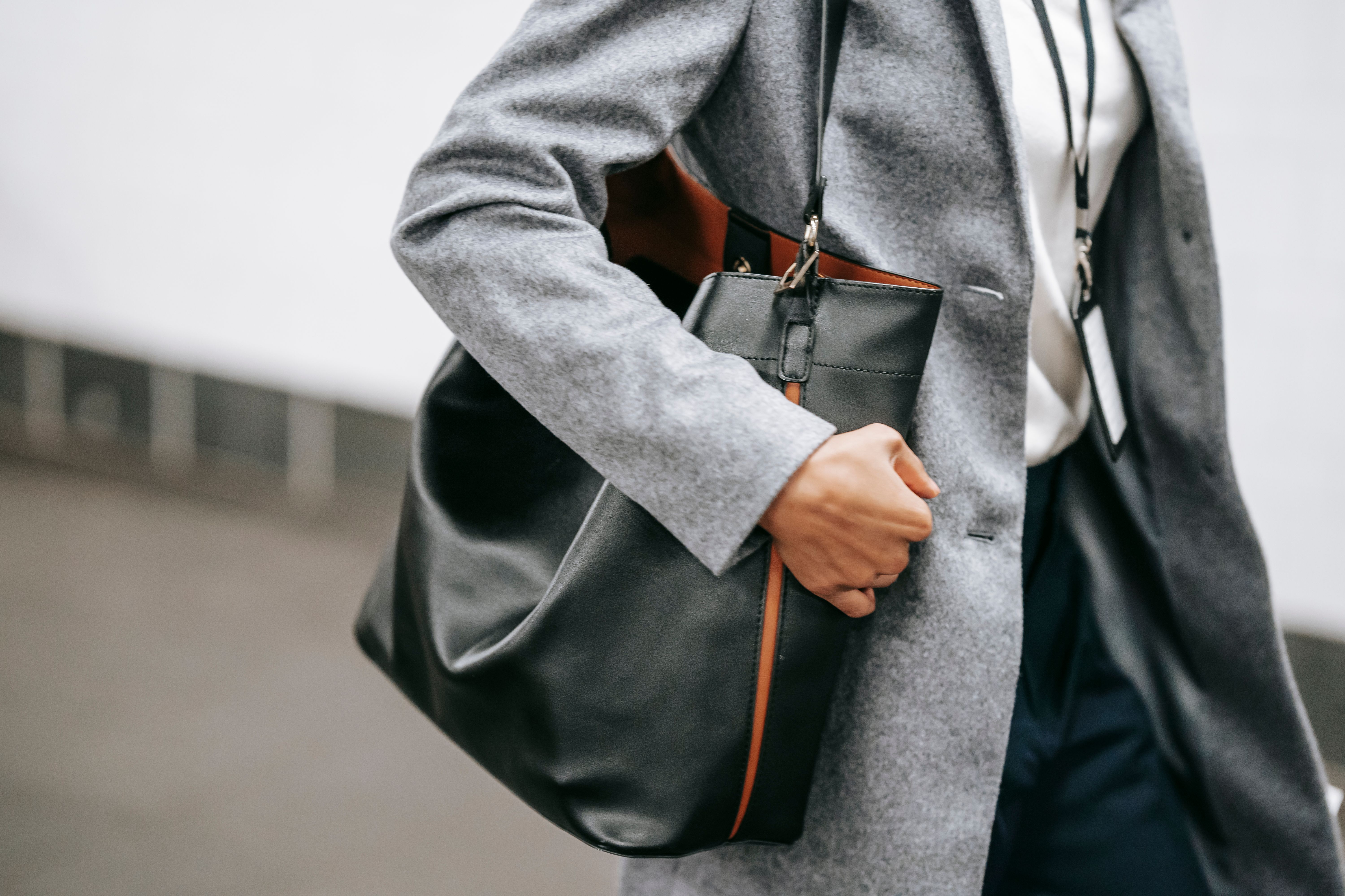 Woman carrying a black leather shoulder bag for everyday use