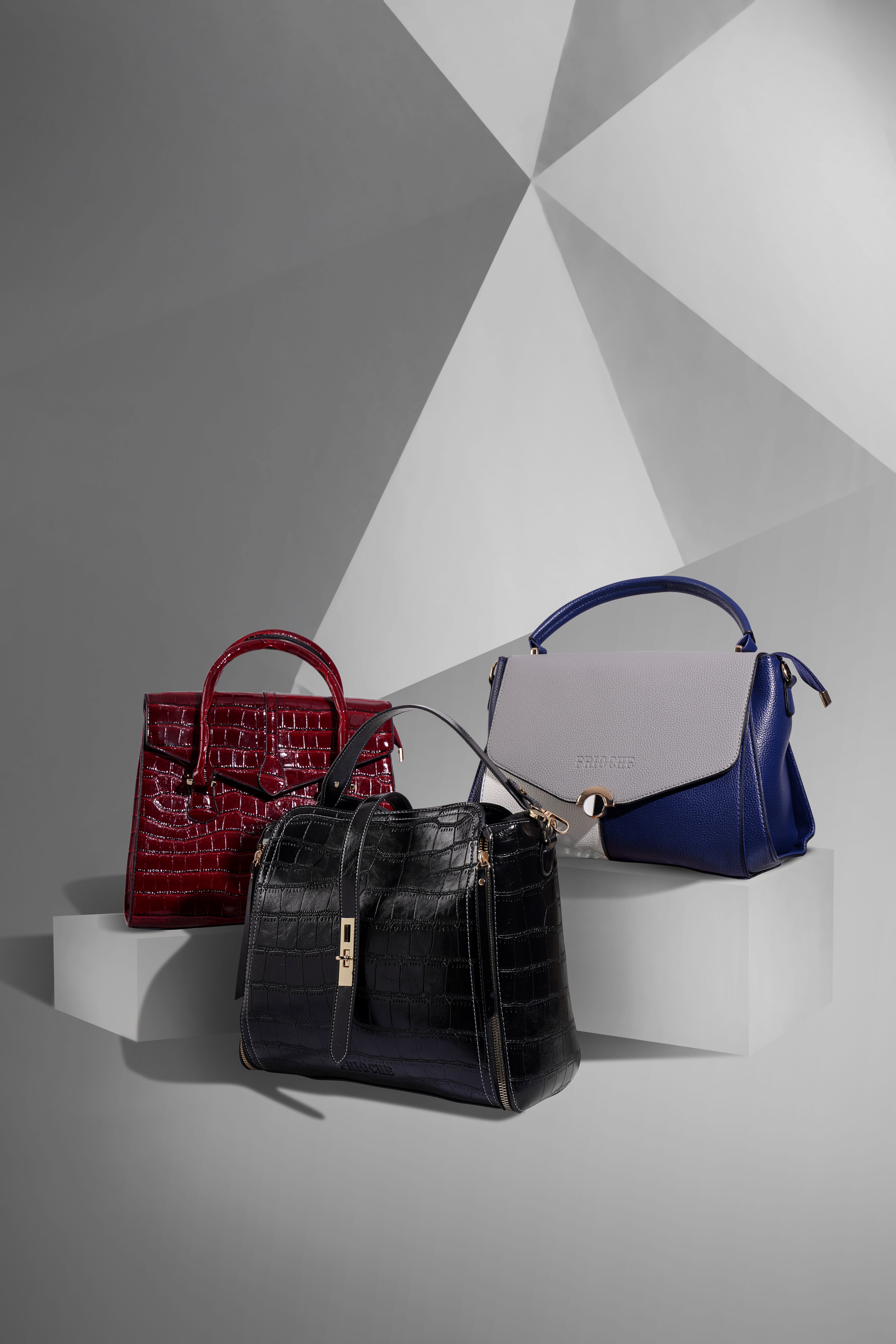 Modern handbag collection featuring black, blue, and red designer-inspired bags