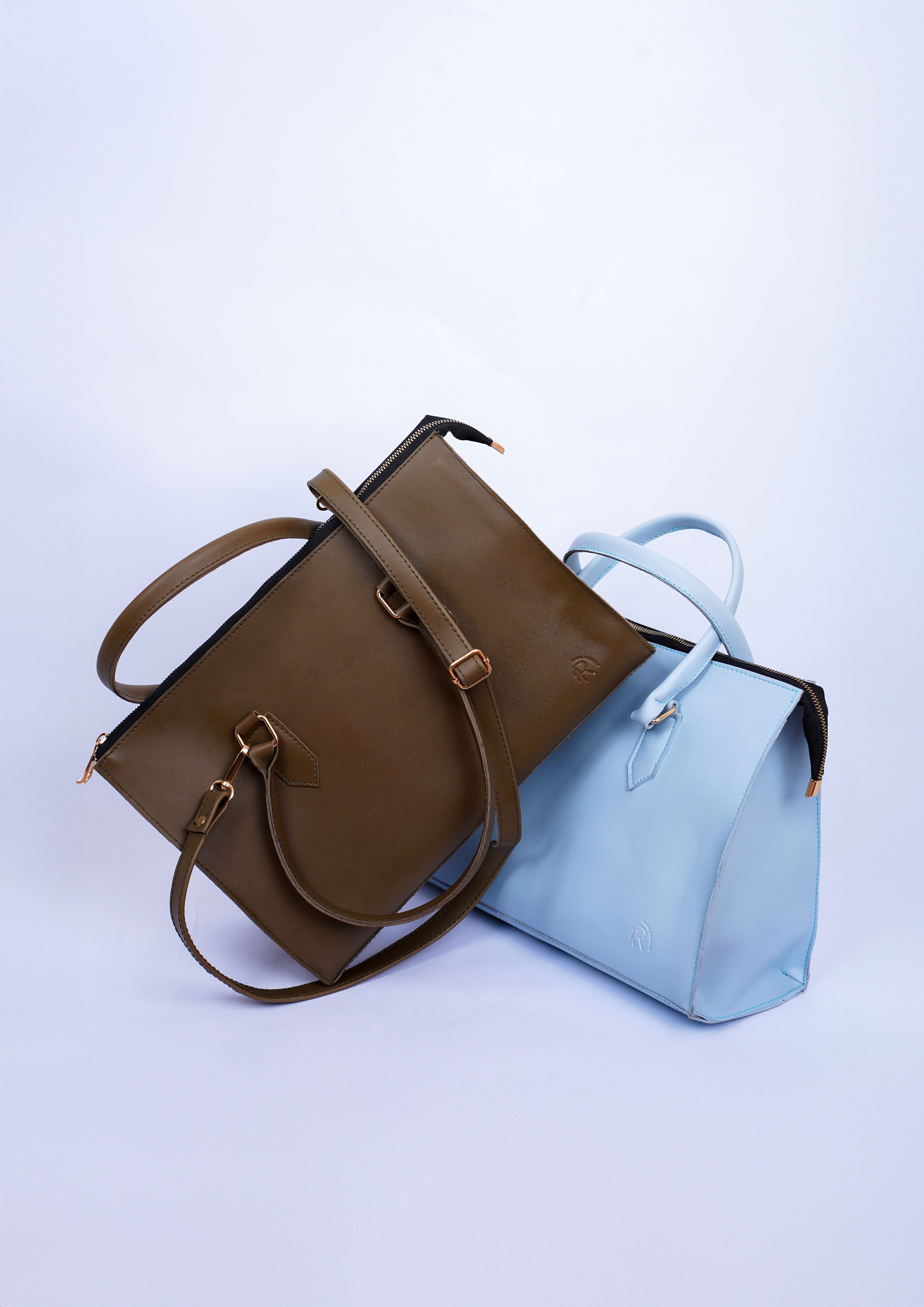 Stylish women's handbags in brown and light blue displayed together