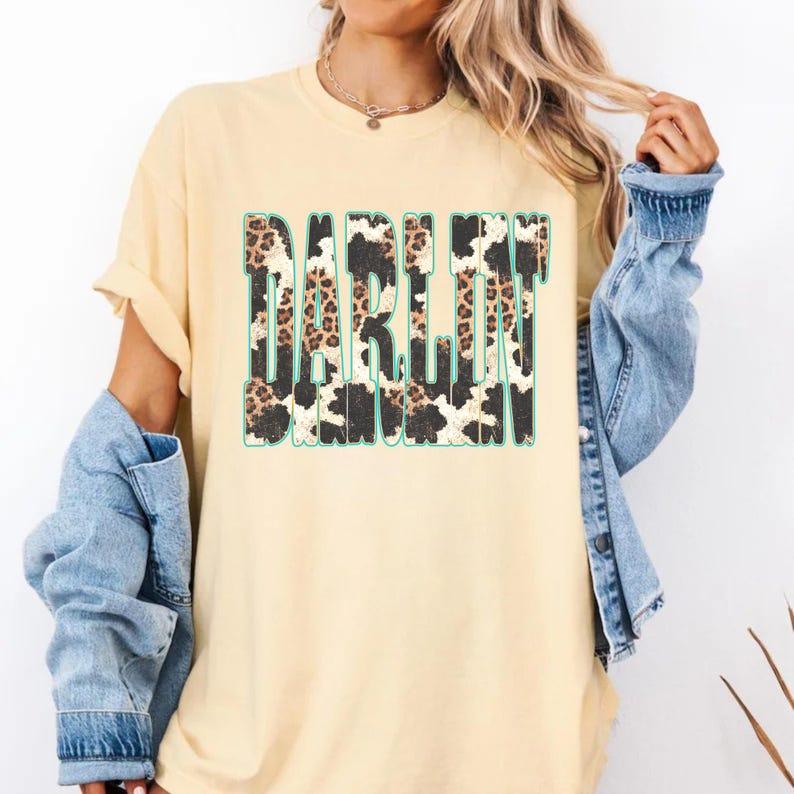 Women's Darlin Graphic Short Sleeve T-Shirt Ladies Western Cowgirl Casual Loose Top Retro Rodeo Aesthetic Cream Yellow Cotton Blend Tee Leopard Cow Print Darlin Shirt Summer Country Music Concert Outfit 2