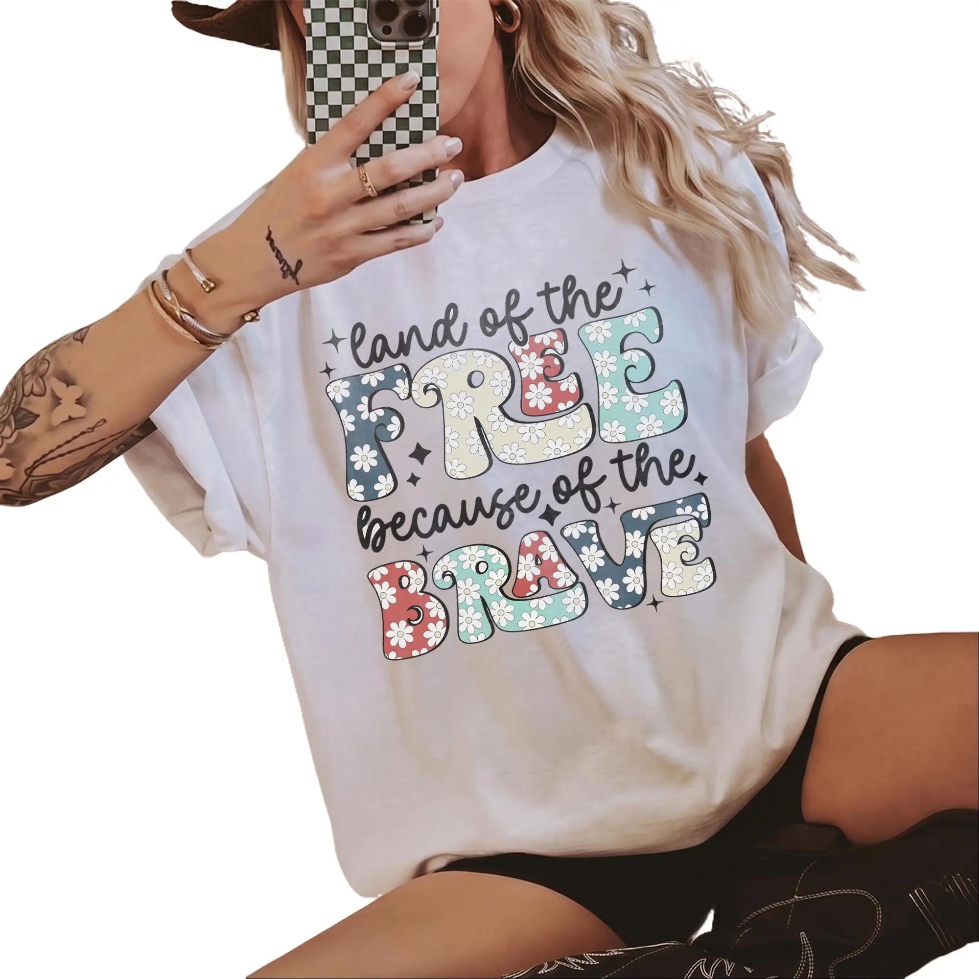 Land Of The Free Because Of The Brave Patriotic Graphic T-Shirt For Women Retro Groovy Floral Western Aesthetic White Cotton Oversized Tee 4th Of July Memorial Day USA Pride Summer Festival Top Outfit Idea 4