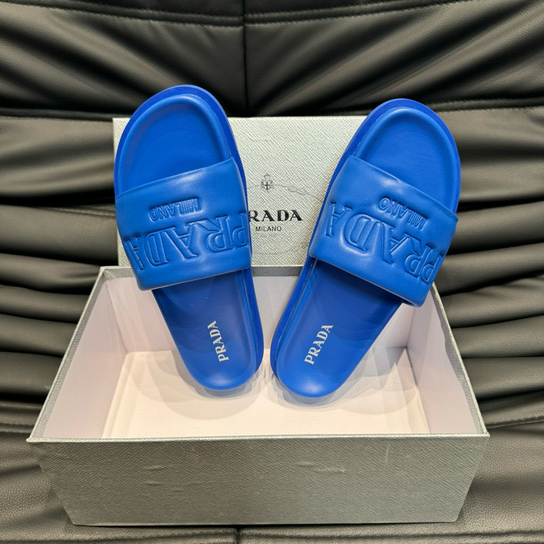 Prada Debossed Logo Padded Nappa Slides In Blue