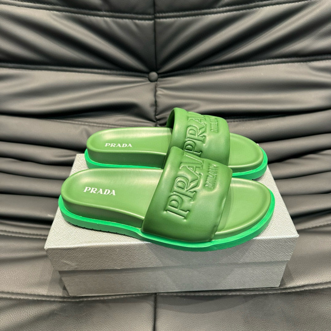 Prada Debossed Logo Padded Nappa Slides In Green