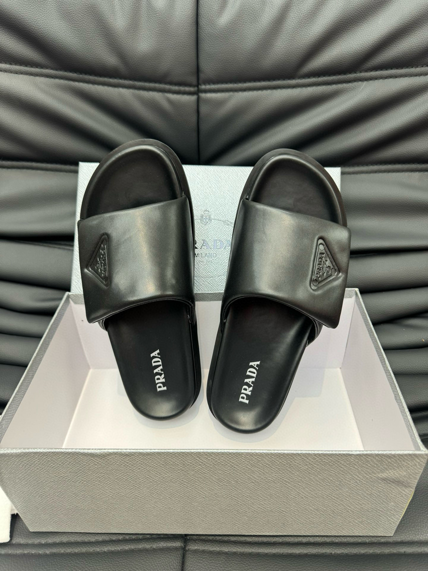 Prada Debossed Triangle Logo Soft Padded Nappa Leather Slides In Black