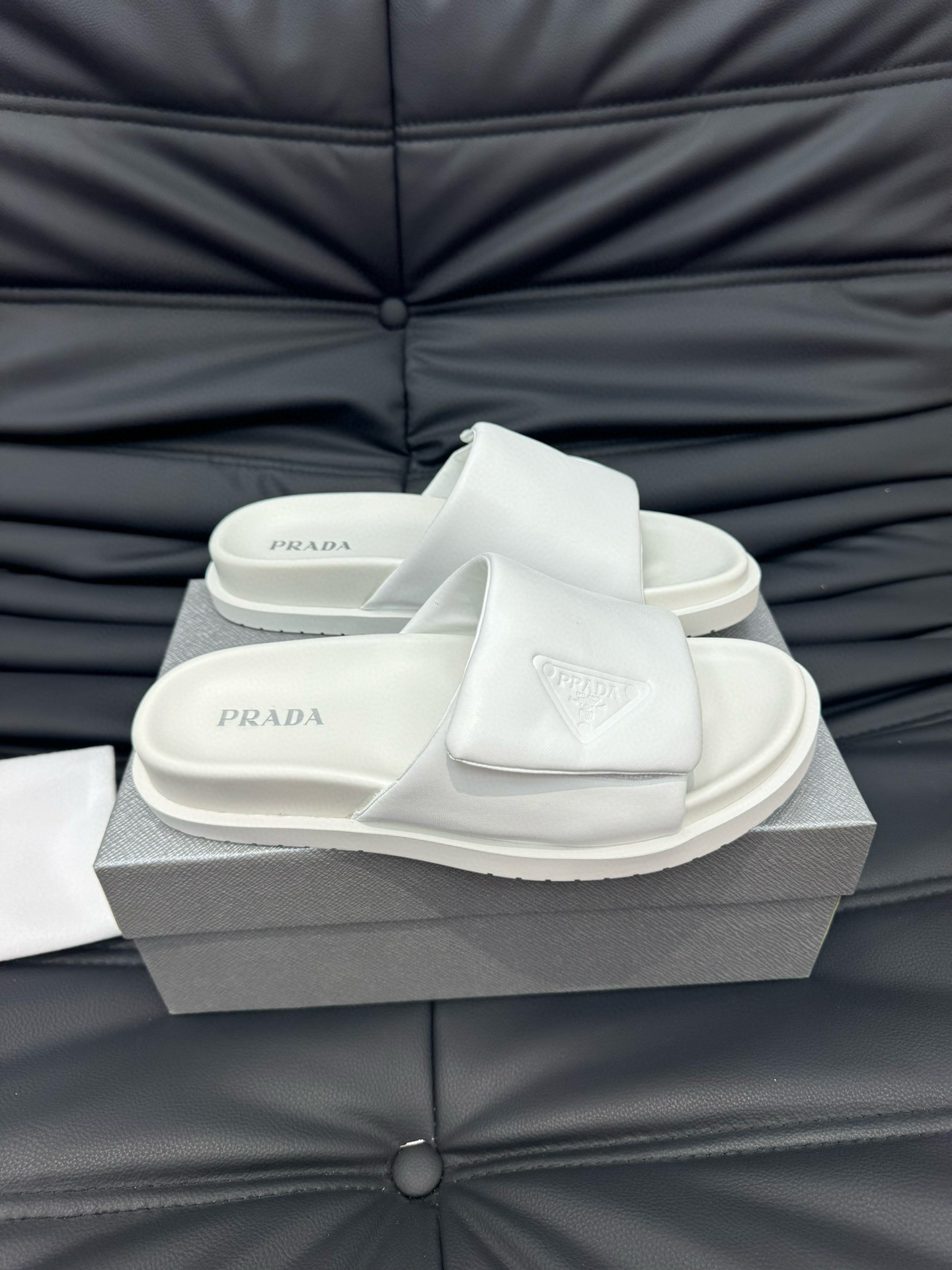 Prada Debossed Triangle Logo Soft Padded Nappa Leather Slides In White