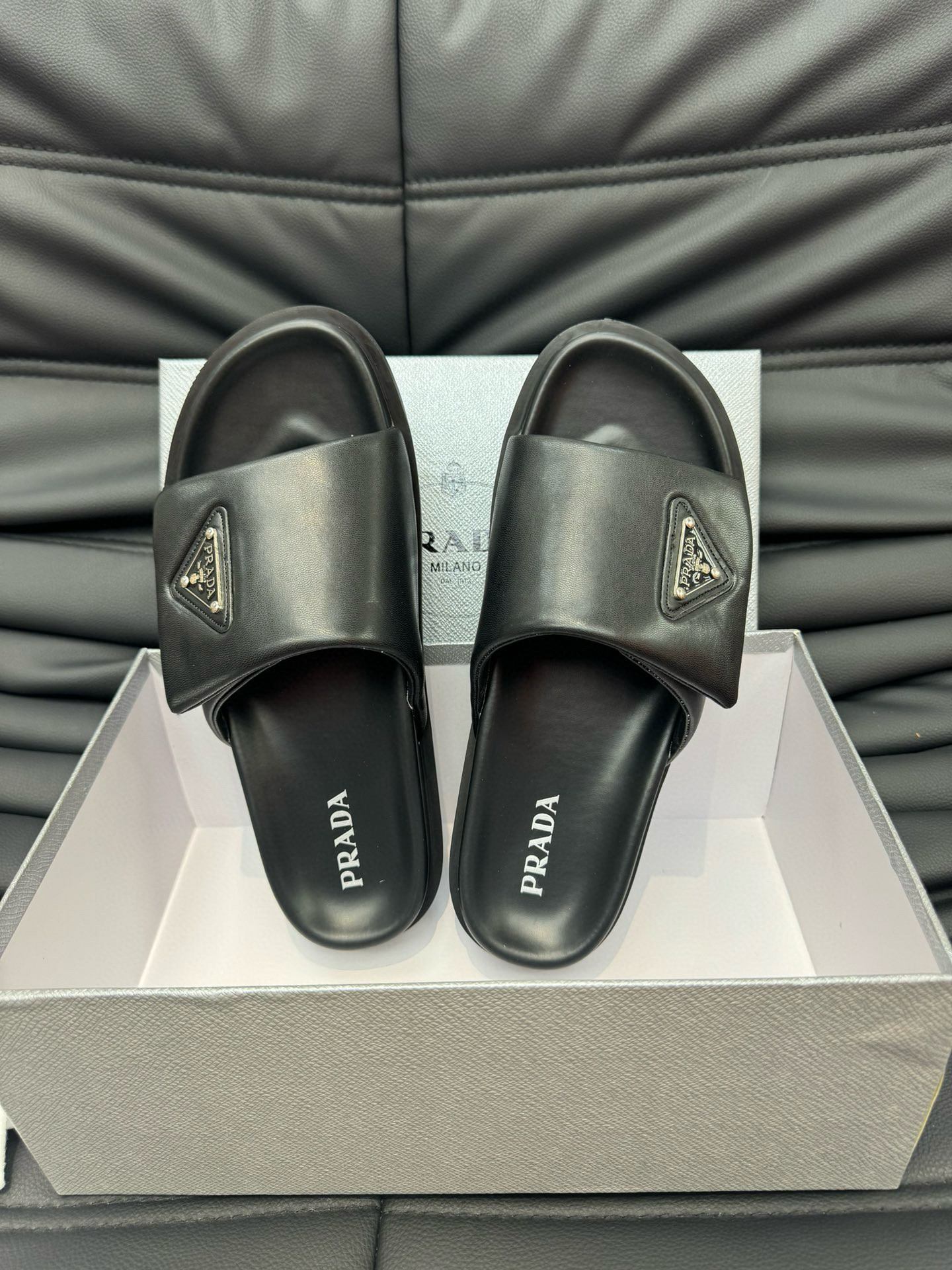 Prada Metal Triangle Logo Soft Padded Nappa Leather Slides In Black