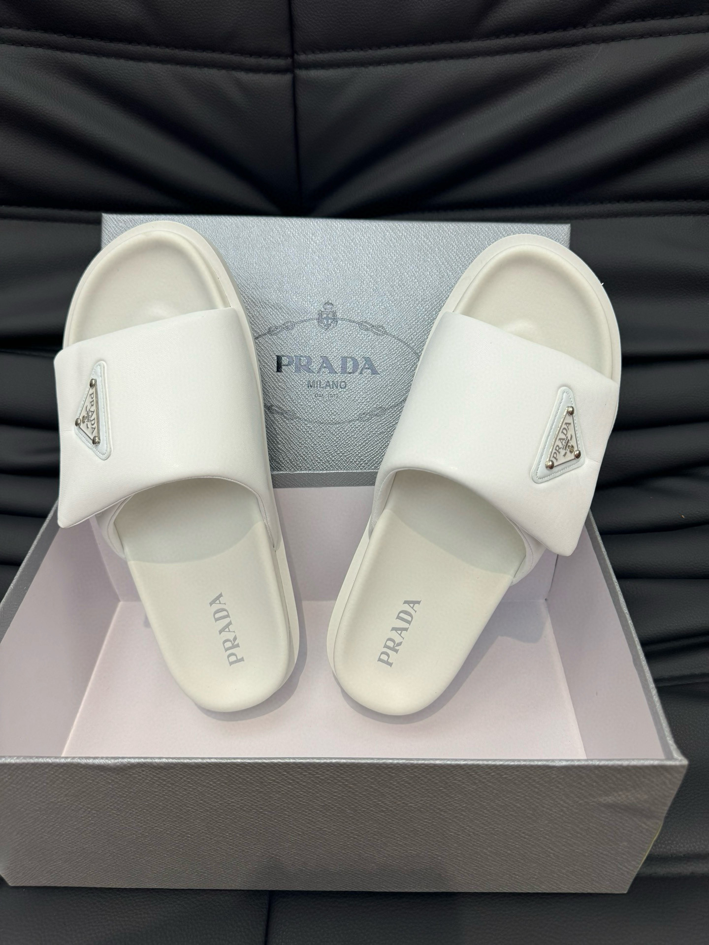 Prada Metal Triangle Logo Soft Padded Nappa Leather Slides In White